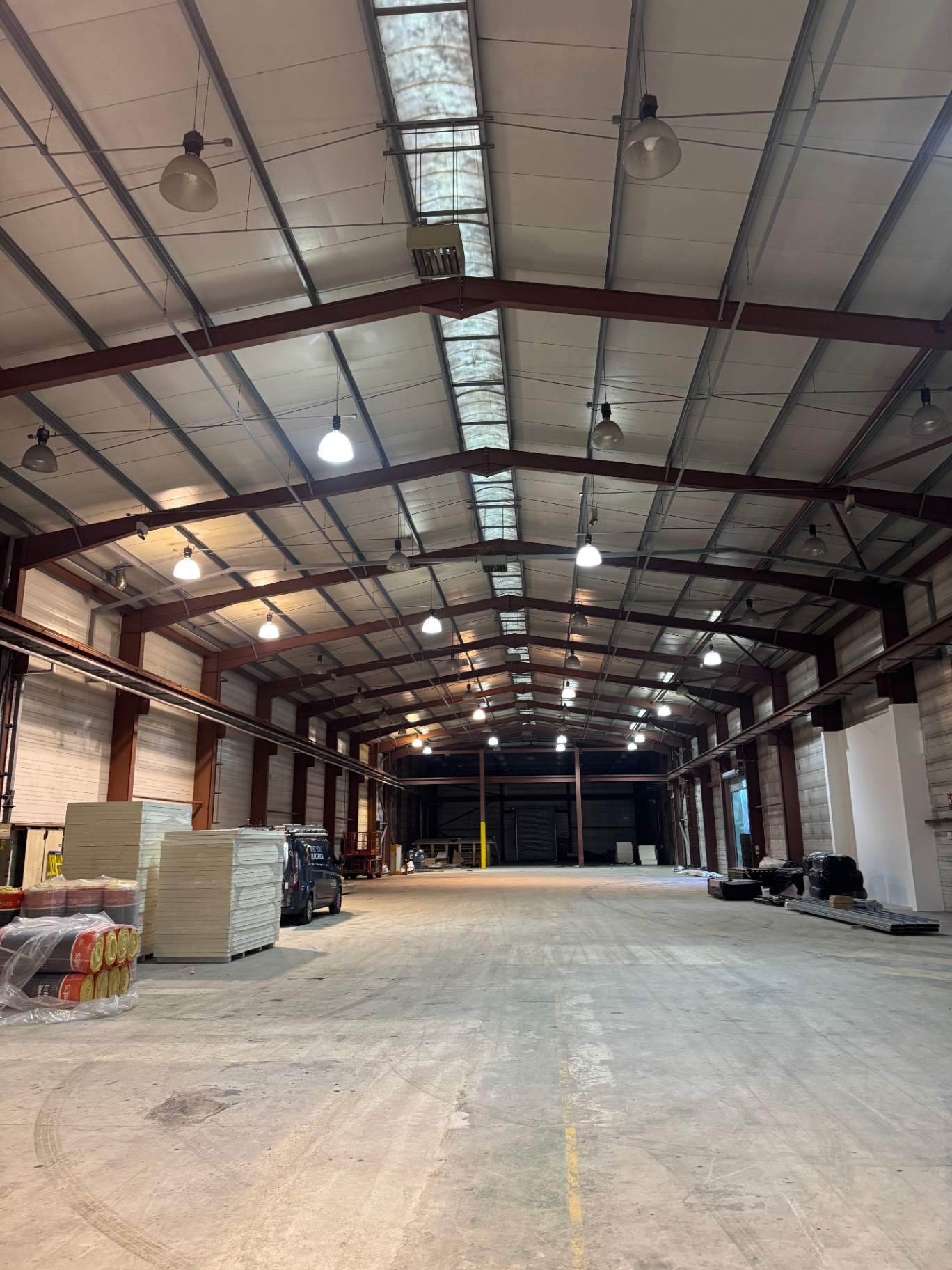 Commercial warehouse fit-out in progress with overhead lighting
