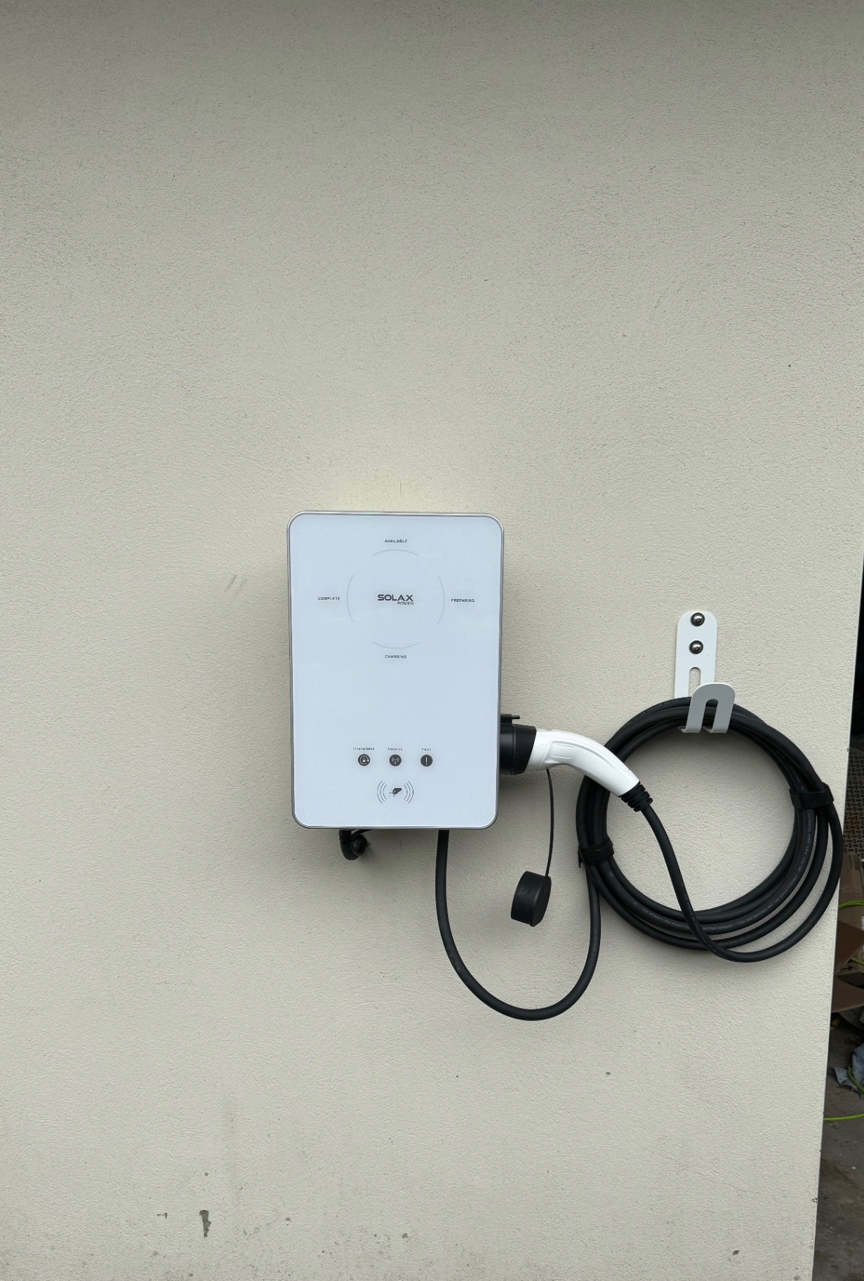 Solax Power EV charger installed on a rendered wall